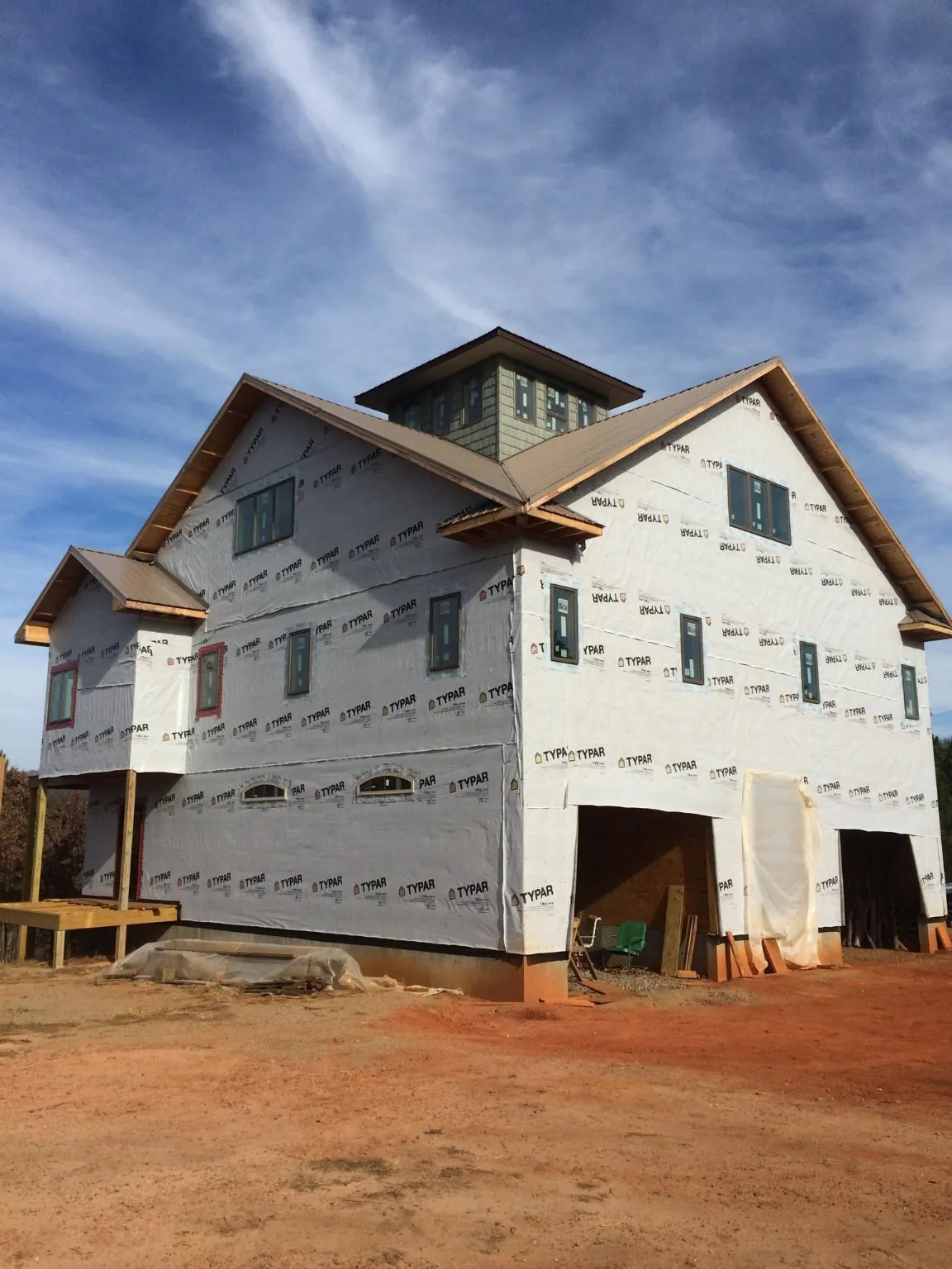 New two story house under construction with a cupola and gabled roofs in Enid